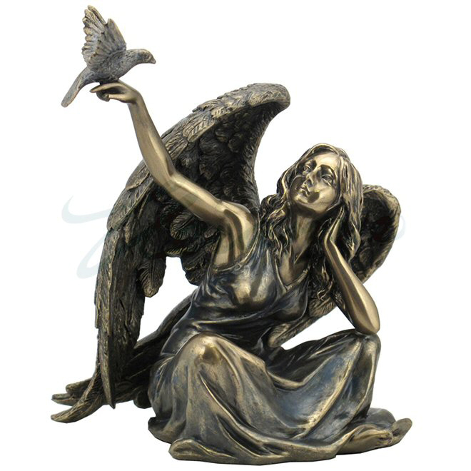bronze angel sitting with dove bird on right hand sculpture
